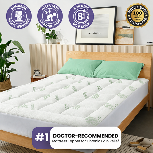 White quilted mattress topper on a light wood bed with two mint pillows