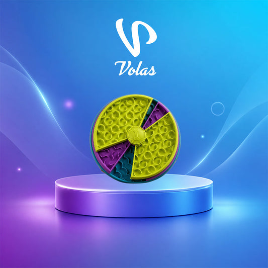 Round puzzle feeder with six coloured wedges and a dimpled surface