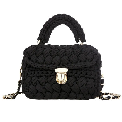 Black woven handbag with a gold clasp on a white background